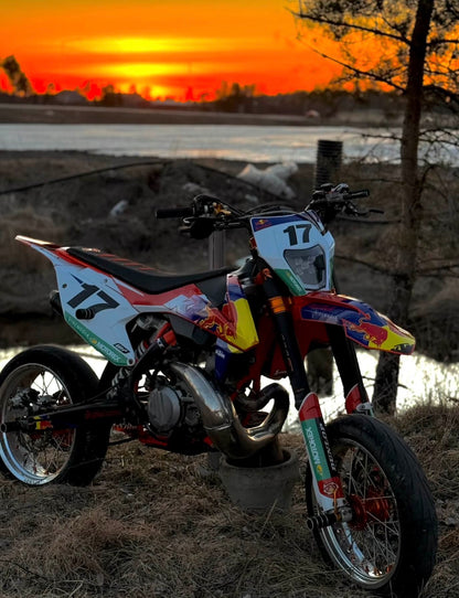 KTM supermoto on Sturdy Racing wheels at sunset – silver rim, orange hub