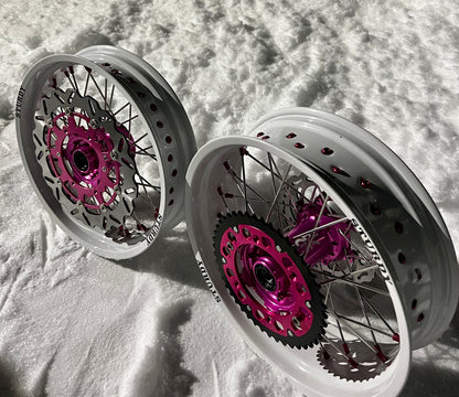 Sturdy custom supermoto wheels – silver rims, pink hubs